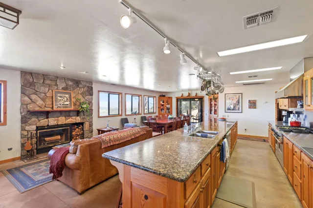 a living room with furniture a fireplace and a large window