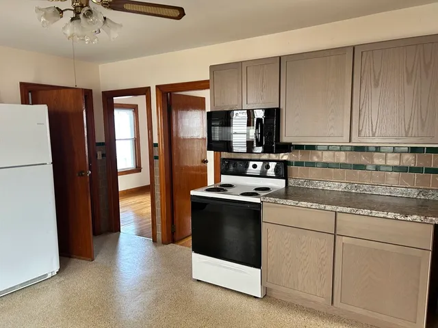 a kitchen with stainless steel appliances a refrigerator stove and microwave