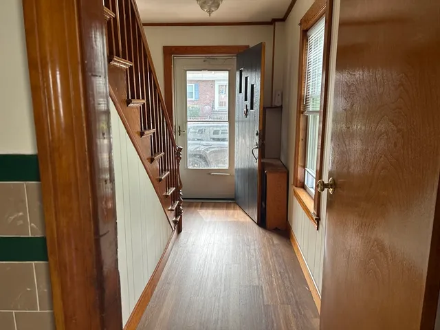 a view of entryway with wooden floor and stairs