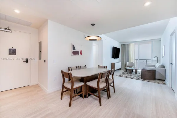 a utility room with stainless steel appliances a stove a sink and a refrigerator