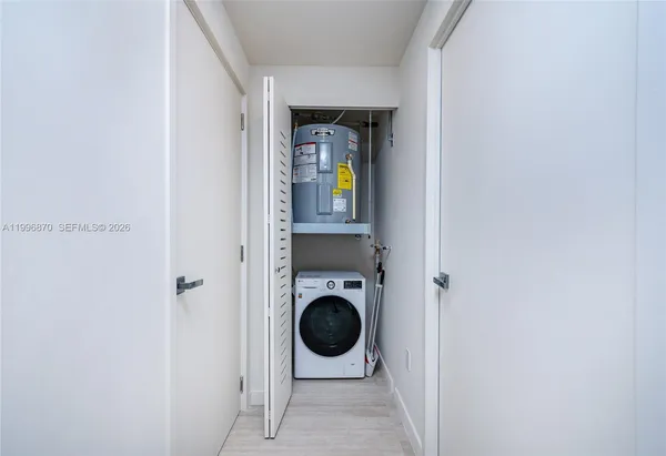 a room with cabinets and refrigerator