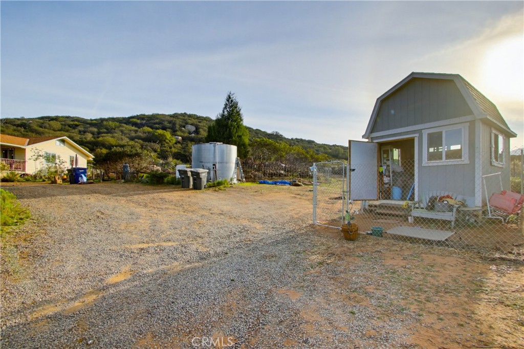 1473 Arnoldo Road Dulzura, CA 91917 - Photo 16 of 19 a view of a house with backyard and sitting area