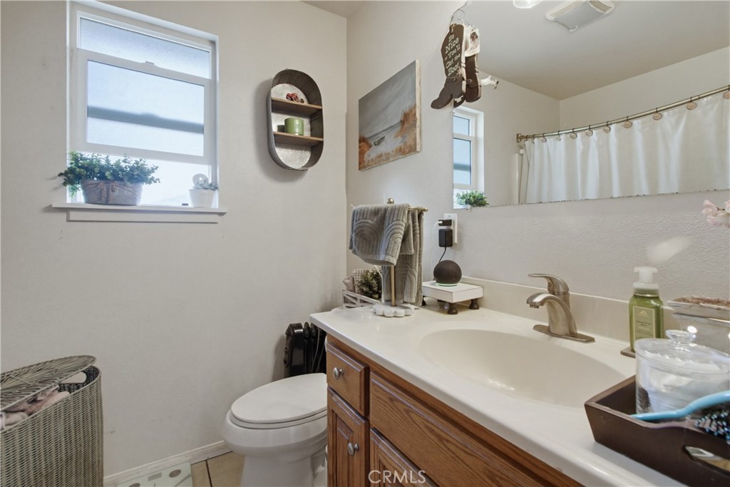 1473 Arnoldo Road Dulzura, CA 91917 - Photo 8 of 19 a bathroom with a sink a toilet and a mirror