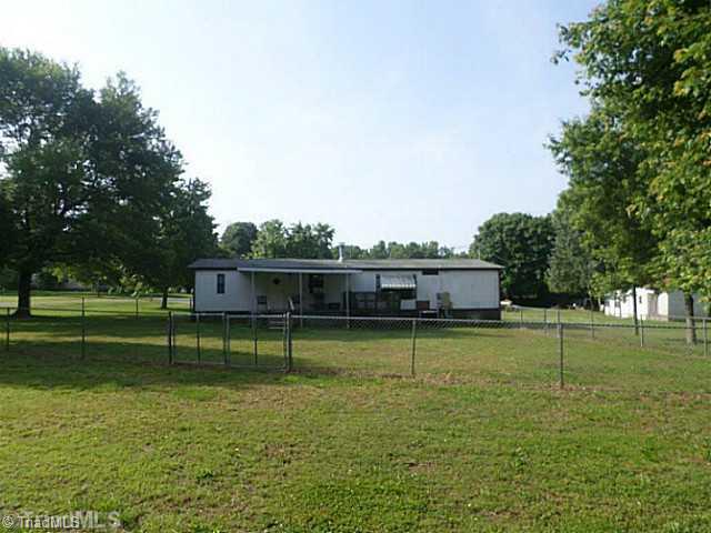 152 Deer Trail Road Reidsville, NC 27320 - Photo 2 of 15 Exterior Back. fenced area back view of home