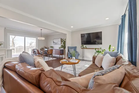 a large white kitchen with lots of counter space and stainless steel appliances
