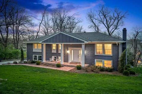 a front view of a house with a yard table and chairs
