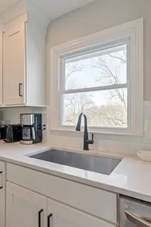 a view of porch with a table and chairs