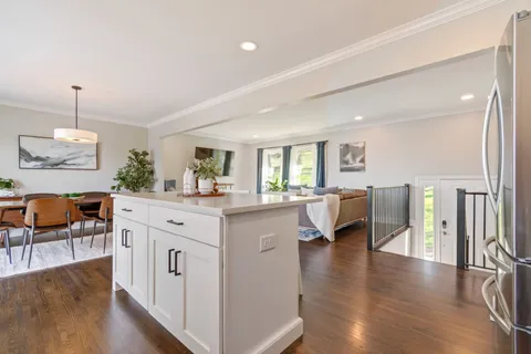 a view of a patio with a table chairs and a potted plant