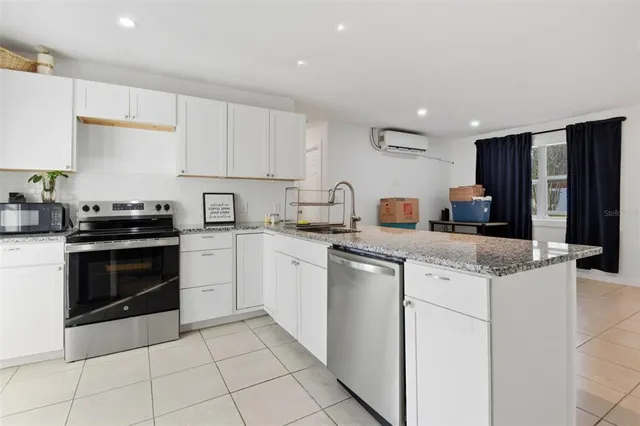 a kitchen with a stove sink and refrigerator