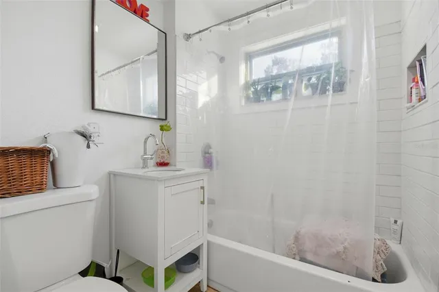 a bathroom with a bathtub sink and mirror