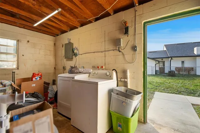 a utility room with sink dryer and washer