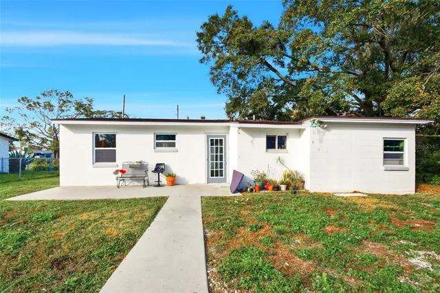 a front view of house with yard and outdoor seating