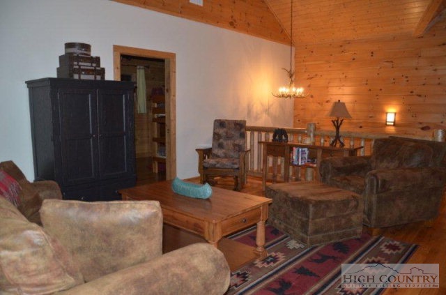 495 Mulberry Mountain Road Boone, NC 28607 - Photo 11 of 36 a living room with couches chairs and kitchen view
