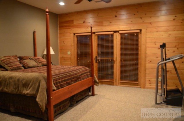 495 Mulberry Mountain Road Boone, NC 28607 - Photo 12 of 36 a bedroom with a bed and a walk in closet
