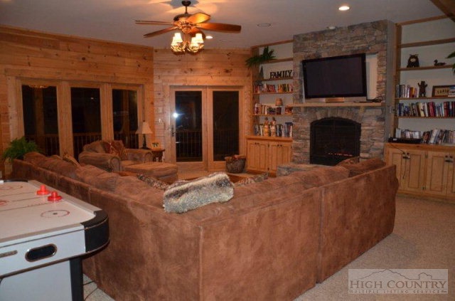 495 Mulberry Mountain Road Boone, NC 28607 - Photo 14 of 36 a living room with fireplace furniture and a flat screen tv