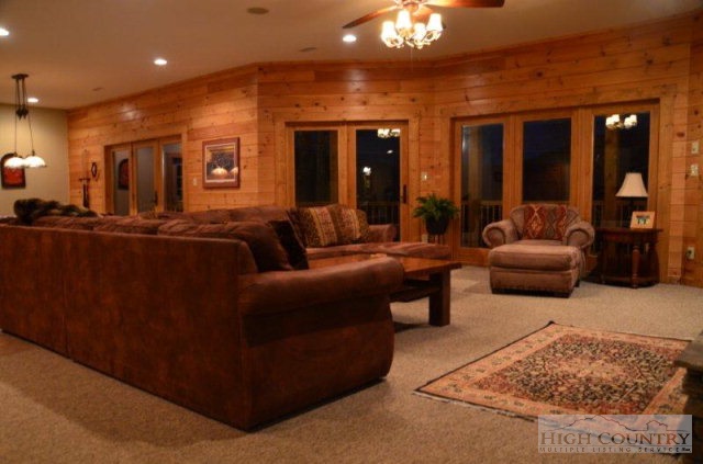 495 Mulberry Mountain Road Boone, NC 28607 - Photo 15 of 36 a living room with furniture and a chandelier