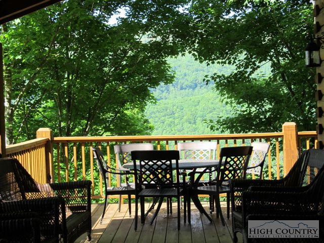 495 Mulberry Mountain Road Boone, NC 28607 - Photo 25 of 36 a view of a balcony with chairs and wooden fence