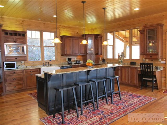 495 Mulberry Mountain Road Boone, NC 28607 - Photo 33 of 36 a kitchen with a large window and dining table