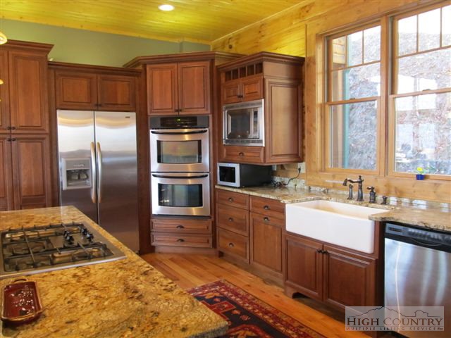 495 Mulberry Mountain Road Boone, NC 28607 - Photo 34 of 36 a kitchen with stainless steel appliances granite countertop a stove a sink and a refrigerator