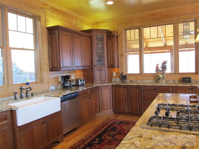 495 Mulberry Mountain Road Boone, NC 28607 - Photo 35 of 36 a kitchen with wooden cabinets and a stove top oven