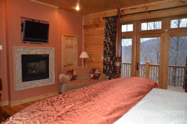 495 Mulberry Mountain Road Boone, NC 28607 - Photo 6 of 36 a bed room with a bed and a television