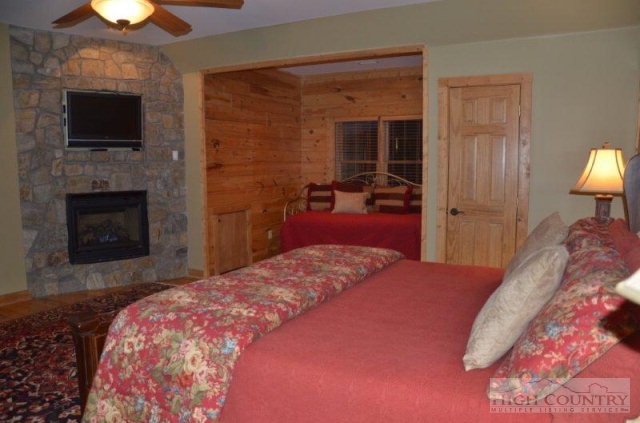 495 Mulberry Mountain Road Boone, NC 28607 - Photo 9 of 36 a bedroom with a bed and a television