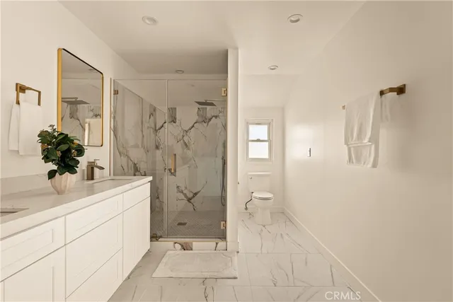 a spacious bathroom with a shower sink and mirror