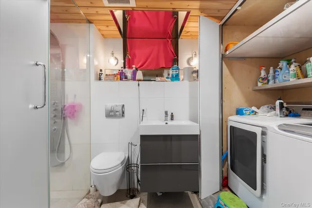 a bathroom with a sink toilet and shower