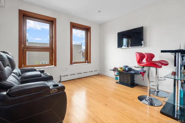a living room with furniture cabinets and a flat screen tv