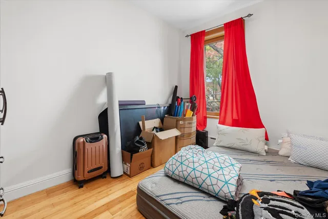 a bed sitting in a bedroom next to a window