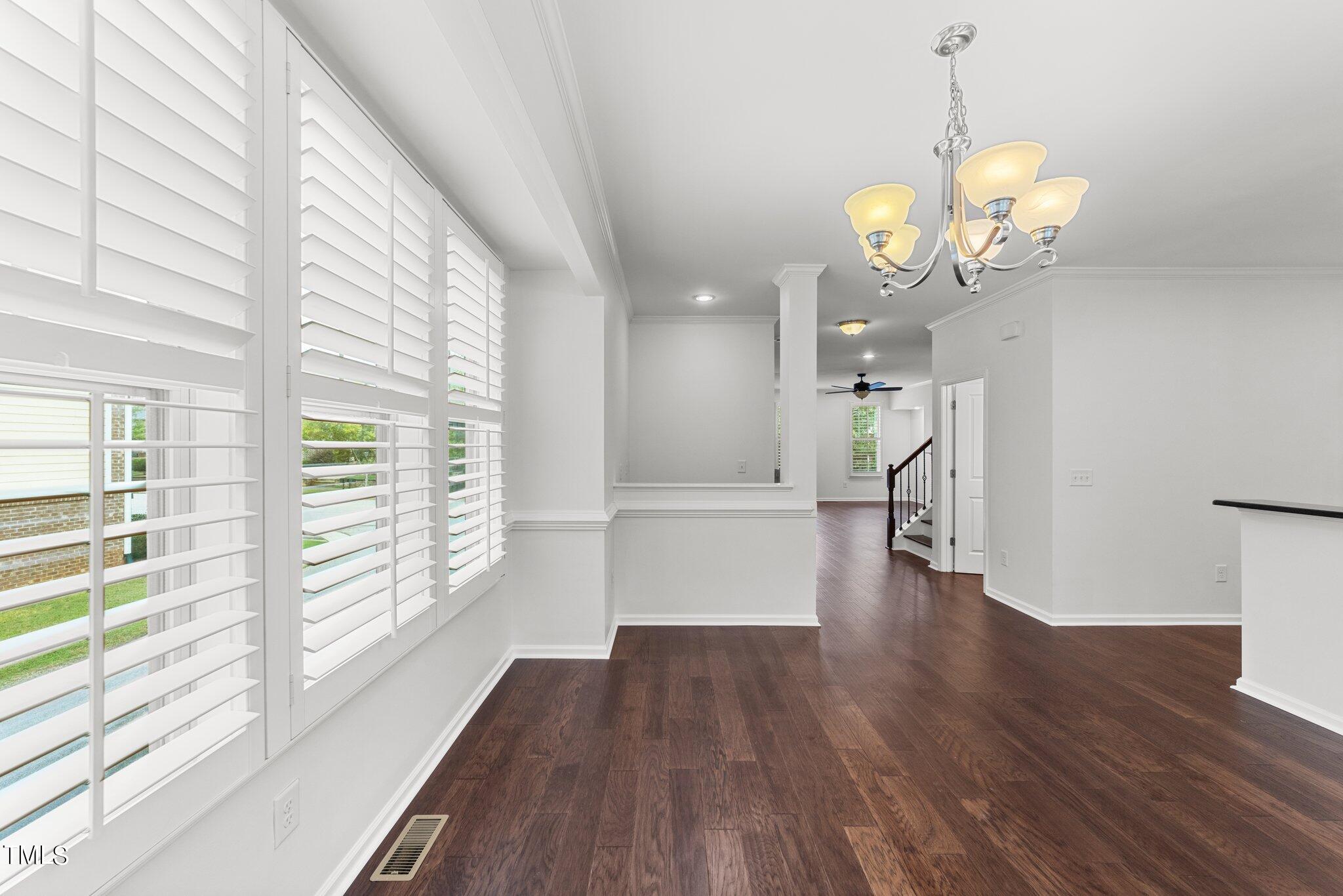 5627 Wade Park Boulevard Raleigh, NC 27607 - Photo 13 of 44 a view of a room with wooden floor and windows
