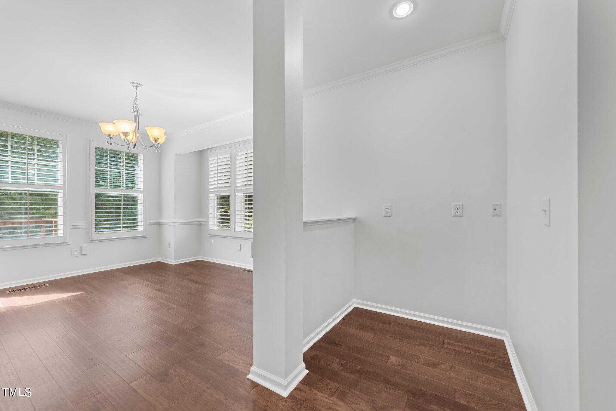 5627 Wade Park Boulevard Raleigh, NC 27607 - Photo 14 of 44 an empty room with wooden floor and windows