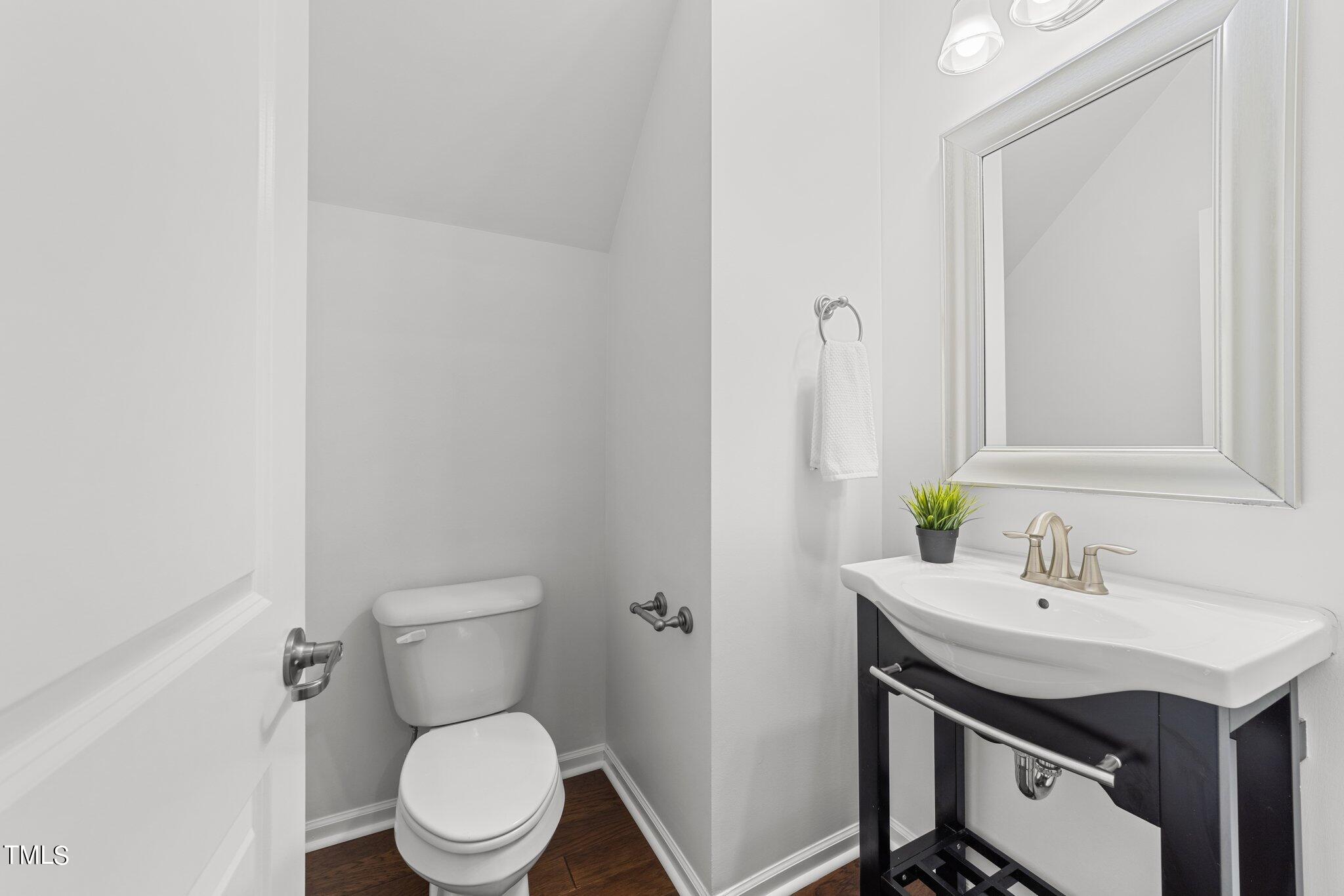 5627 Wade Park Boulevard Raleigh, NC 27607 - Photo 15 of 44 a bathroom with a sink toilet and a mirror