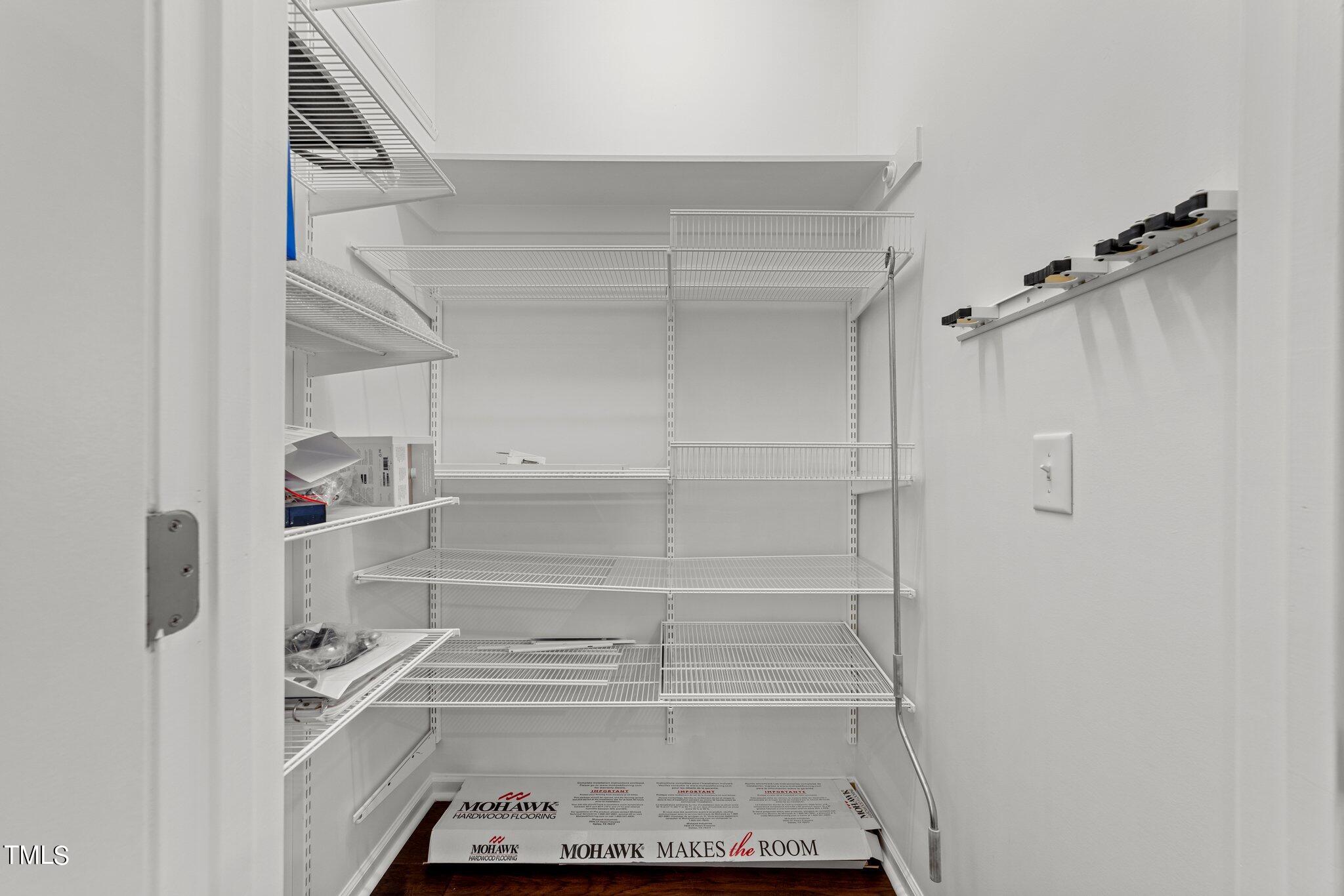 5627 Wade Park Boulevard Raleigh, NC 27607 - Photo 16 of 44 a view of walk in closet with empty racks