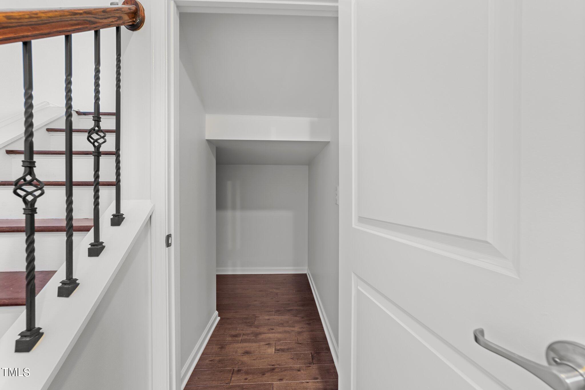 5627 Wade Park Boulevard Raleigh, NC 27607 - Photo 18 of 44 a view of a hallway with wooden floor and staircase