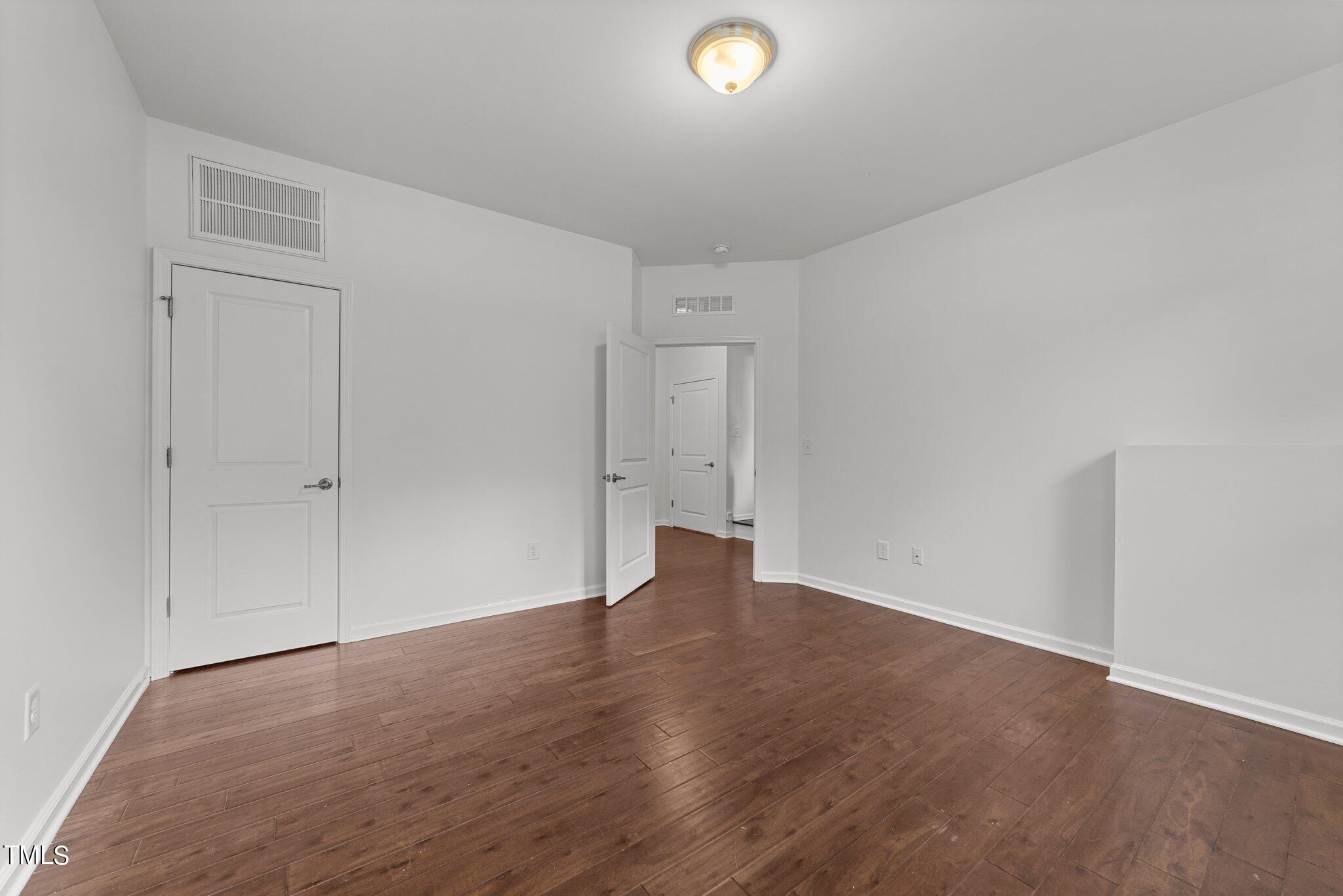 5627 Wade Park Boulevard Raleigh, NC 27607 - Photo 21 of 44 a view of an empty room with wooden floor