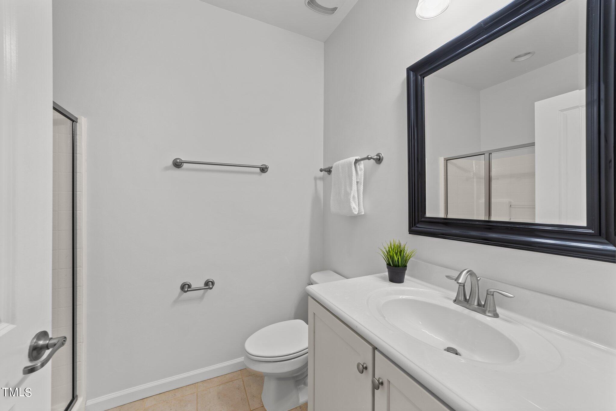 5627 Wade Park Boulevard Raleigh, NC 27607 - Photo 22 of 44 a bathroom with a sink toilet and mirror