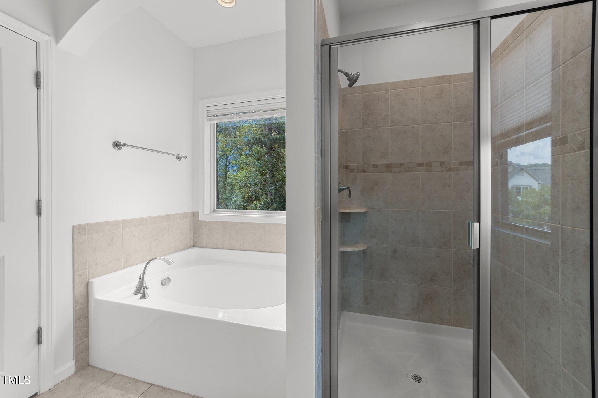 5627 Wade Park Boulevard Raleigh, NC 27607 - Photo 28 of 44 a white bath tub sitting next to a shower