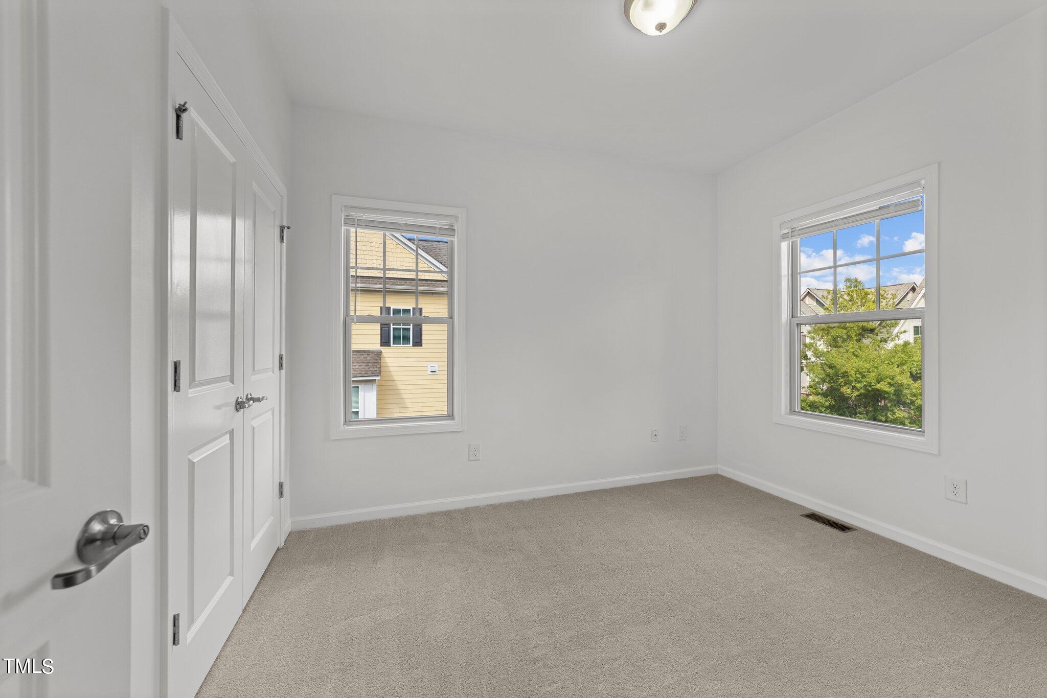 5627 Wade Park Boulevard Raleigh, NC 27607 - Photo 31 of 44 an empty room with windows