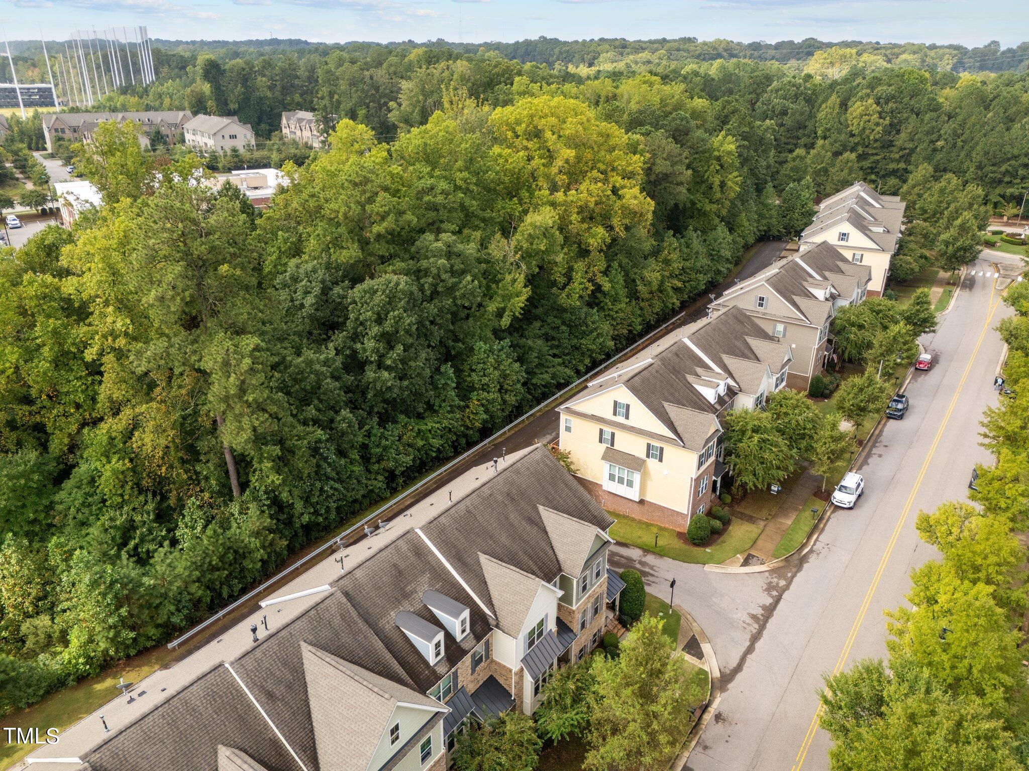 5627 Wade Park Boulevard Raleigh, NC 27607 - Photo 43 of 44 an aerial view of a house with a yard and lake view