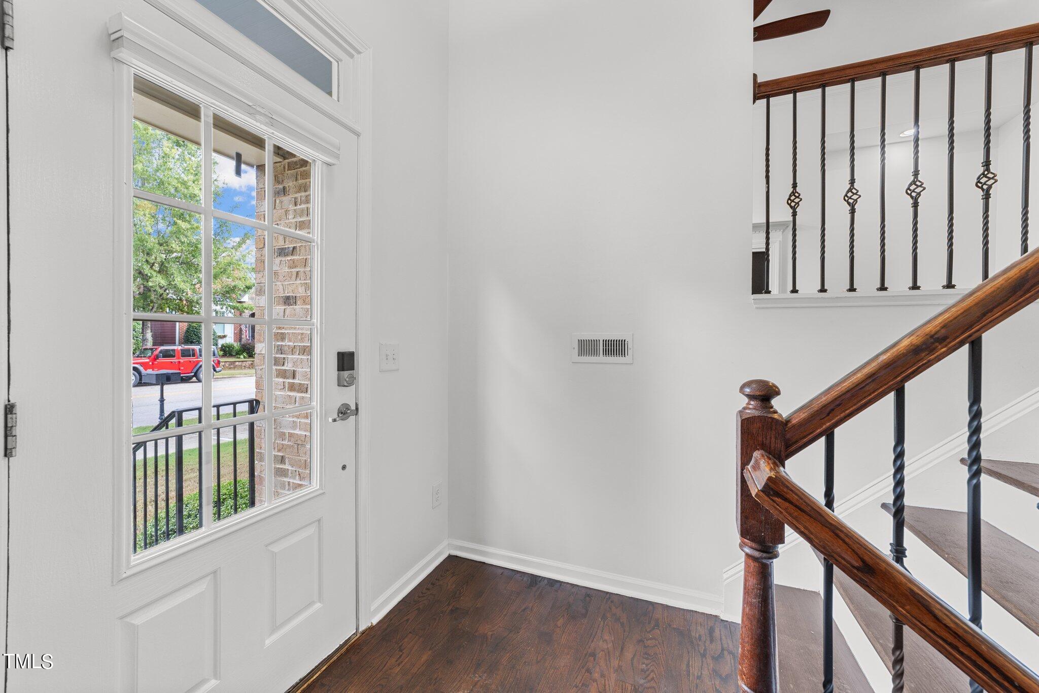 5627 Wade Park Boulevard Raleigh, NC 27607 - Photo 5 of 44 a view of entryway with stairs and wooden floor