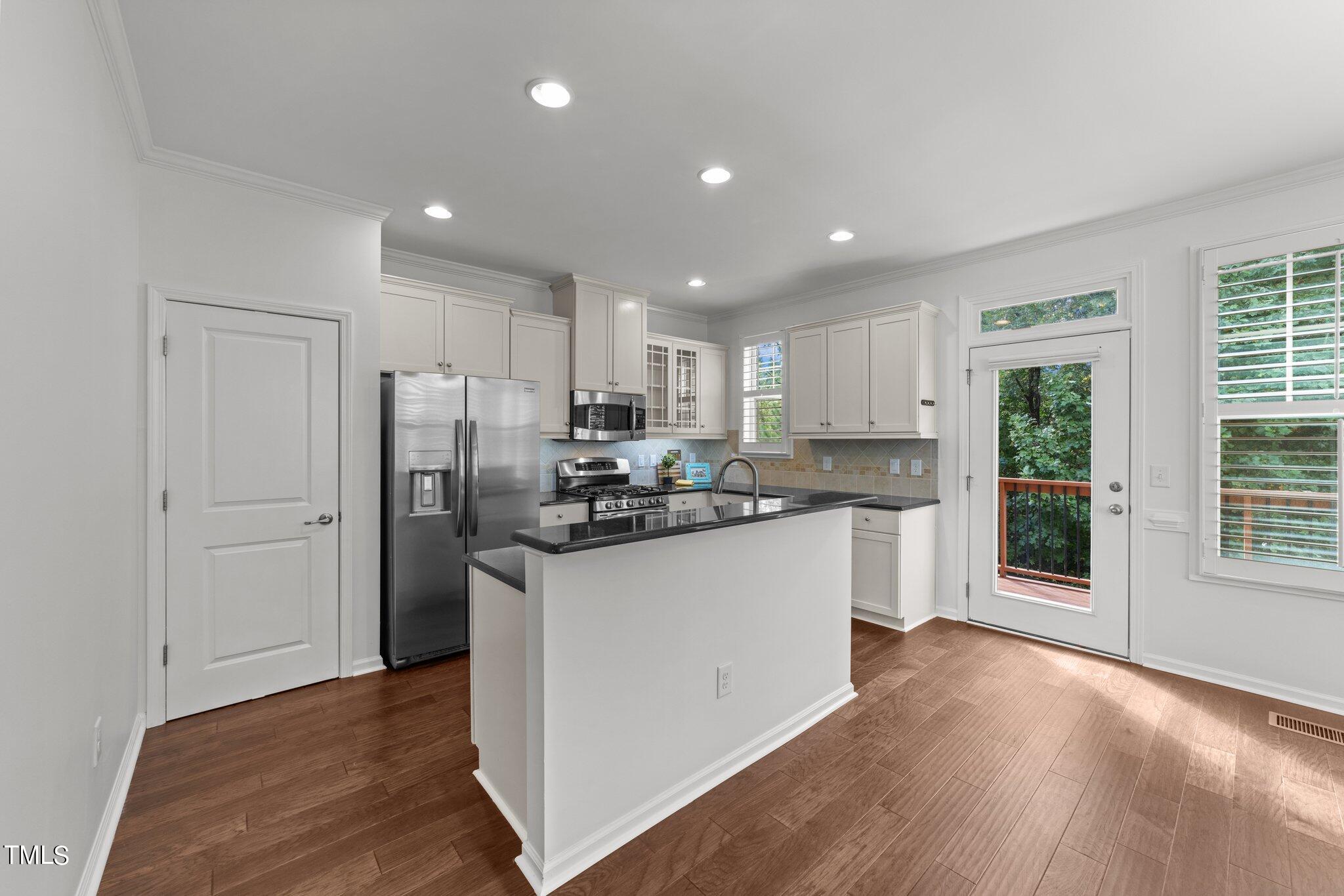 5627 Wade Park Boulevard Raleigh, NC 27607 - Photo 8 of 44 a kitchen with stainless steel appliances granite countertop a refrigerator sink and cabinets
