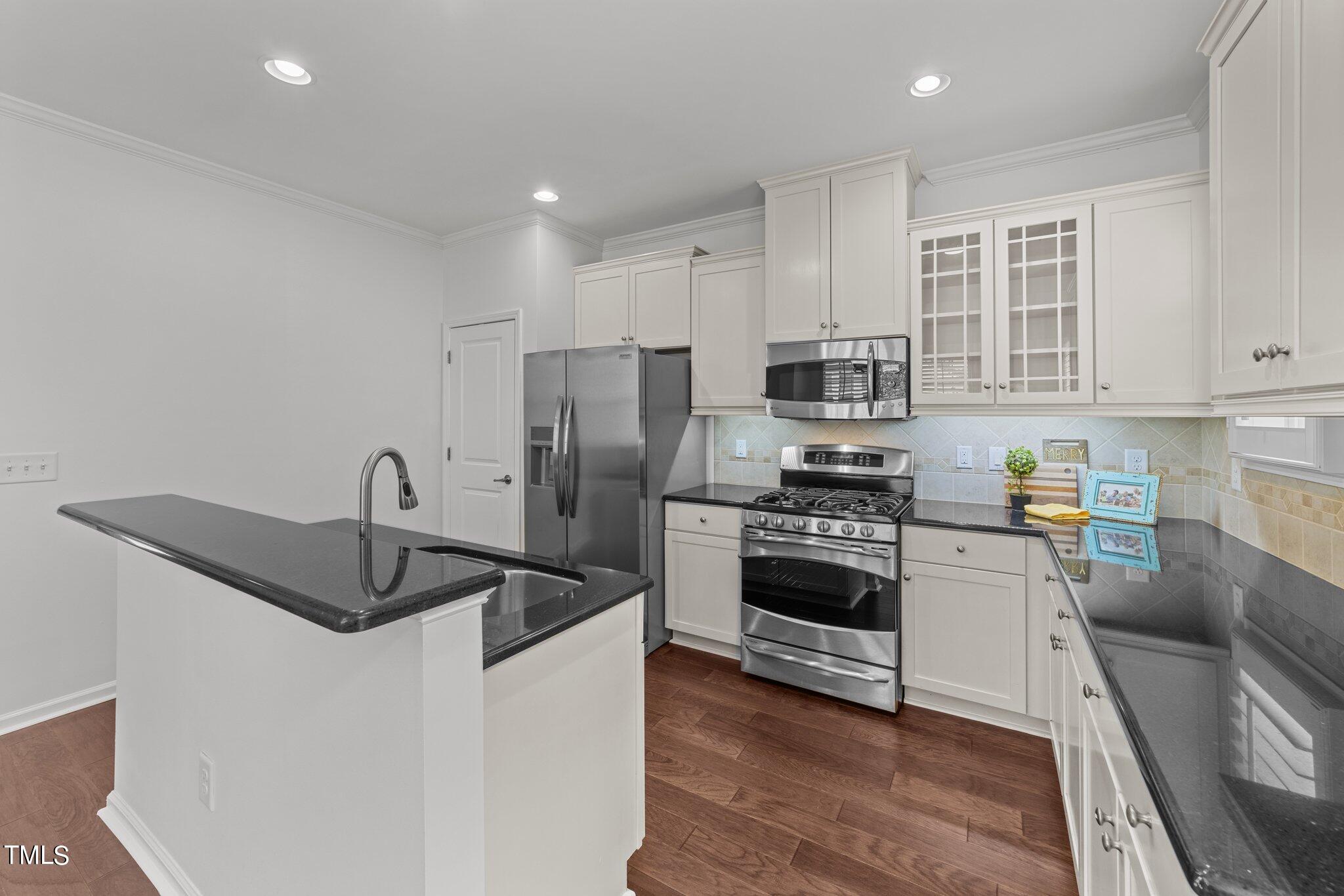 5627 Wade Park Boulevard Raleigh, NC 27607 - Photo 9 of 44 a kitchen with stainless steel appliances granite countertop a sink stove and refrigerator