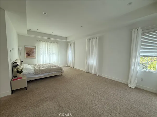 a spacious bedroom with a bed and a window