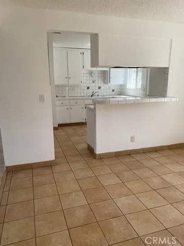a view of a kitchen with white cabinets