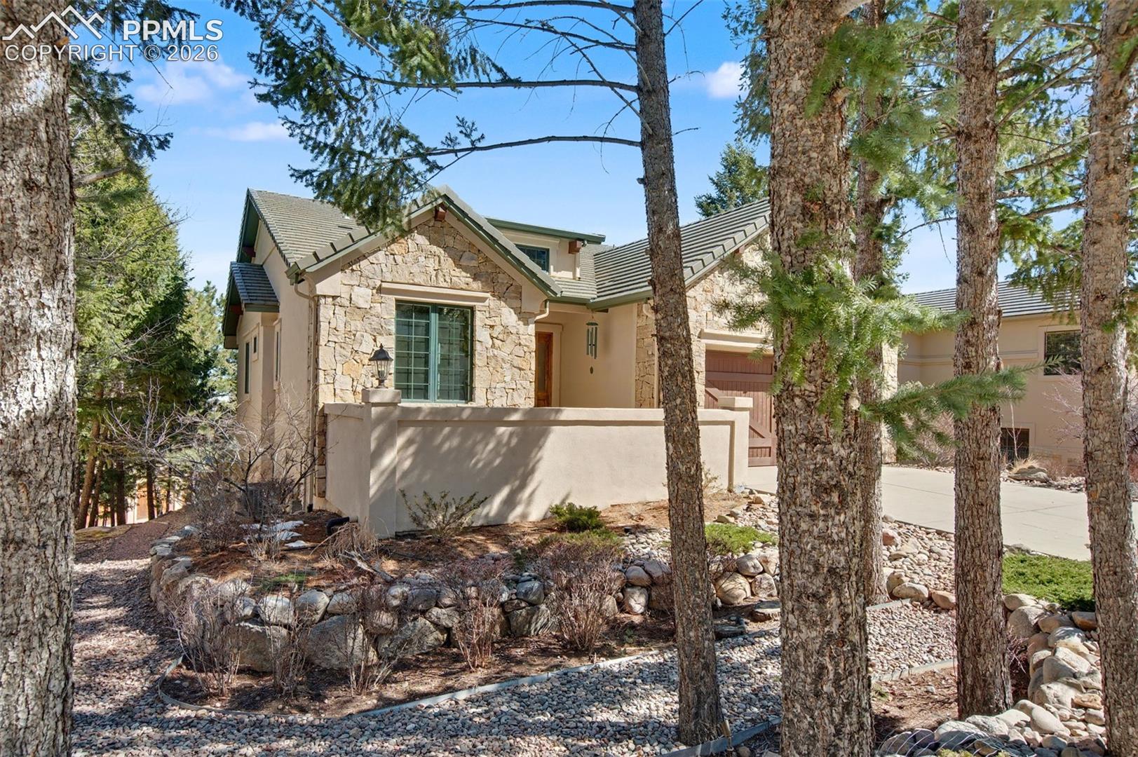 870 Mont Blanc View Colorado Springs, CO 80906 - Photo 3 of 42 Enjoy the front courtyard, surrounded by trees and views of the foothills