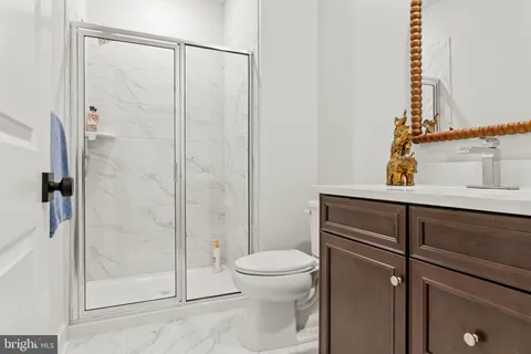 a bathroom with a shower a toilet and a sink