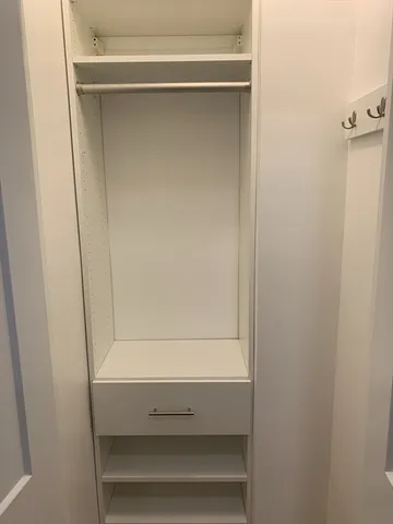 a bathroom with a granite countertop toilet a sink and shower