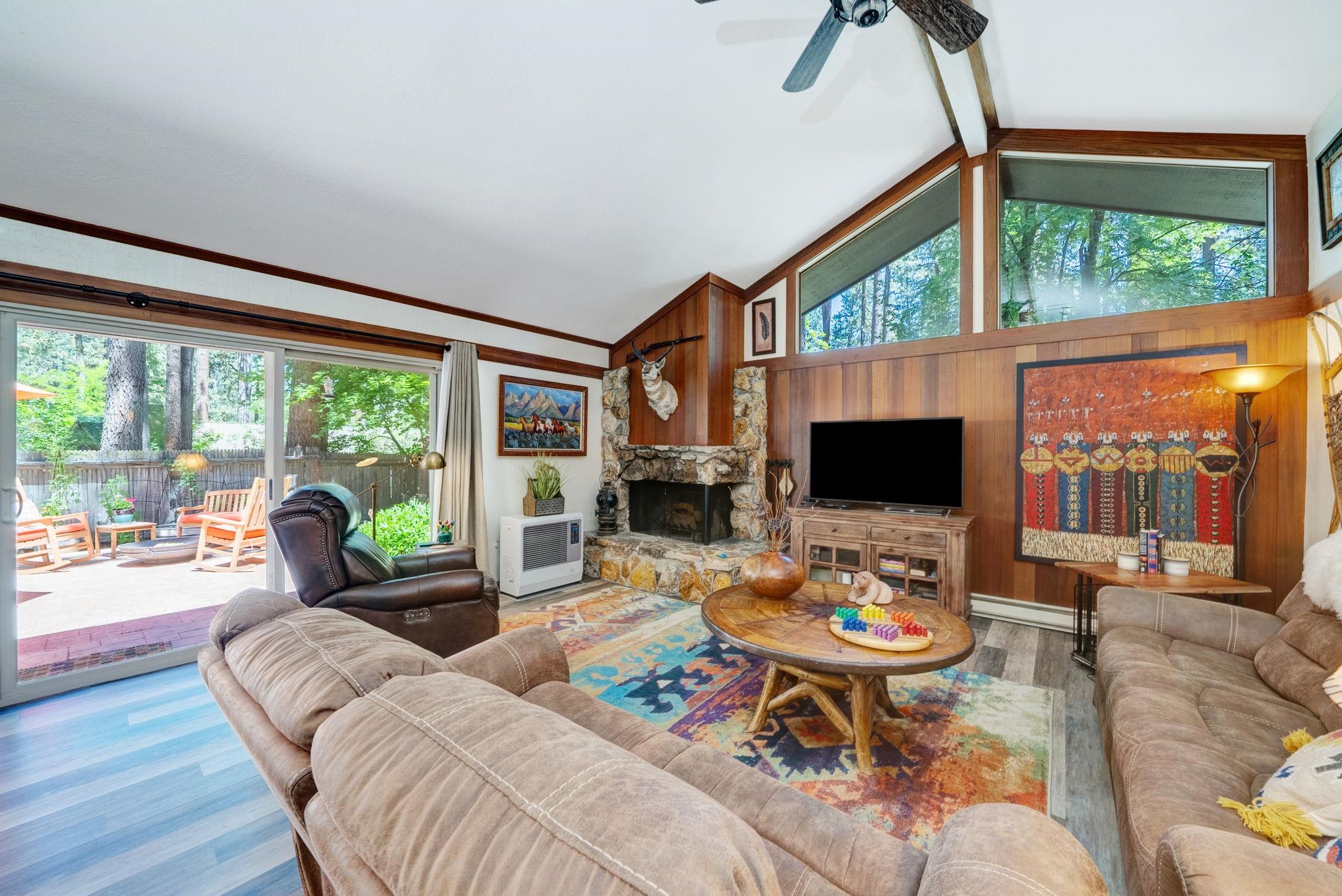 50 Graeagle Meadows Road Graeagle, CA 96103 - Photo 2 of 39 a living room with furniture a flat screen tv and a floor to ceiling window