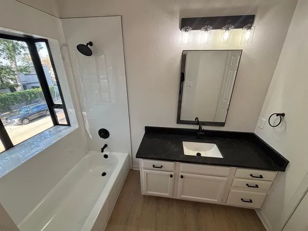 a bathroom with a bathtub and a sink